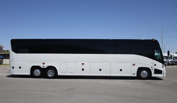 a white 56 passenger charter bus